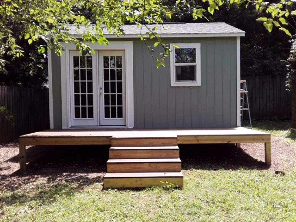 McMahon Construction, Inc. - Custom Shed Builder - gray shed under tree cover